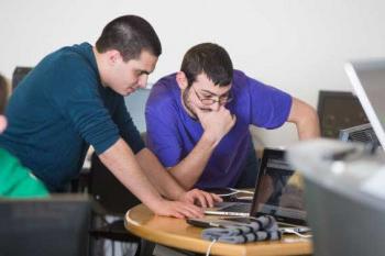 Students working on a computer science project.